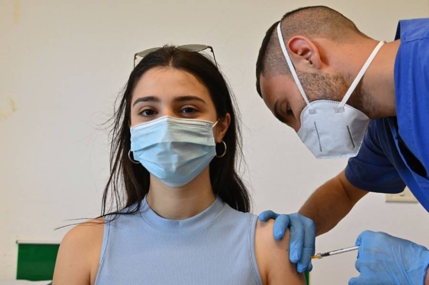 A woman is being vaccinated with the Pfizer-BioNTech vaccine at a Poliambulatorio Health Canter in the southern Italian Pelagie Island of Lampedusa on May 15, 2021. (Photo by Alberto PIZZOLI / AFP)